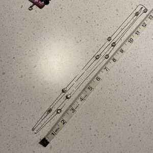 Long necklace made of silver chain and large gemstones